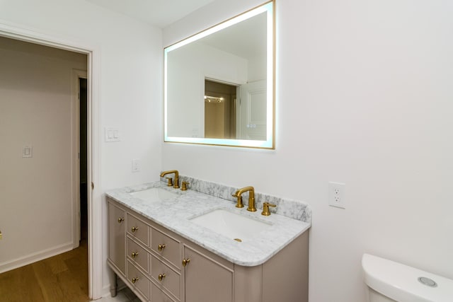 2933 Montavesta Rd, Lexington, KY 40502 - full bath featuring double vanity, wood finished floors, toilet, and baseboards