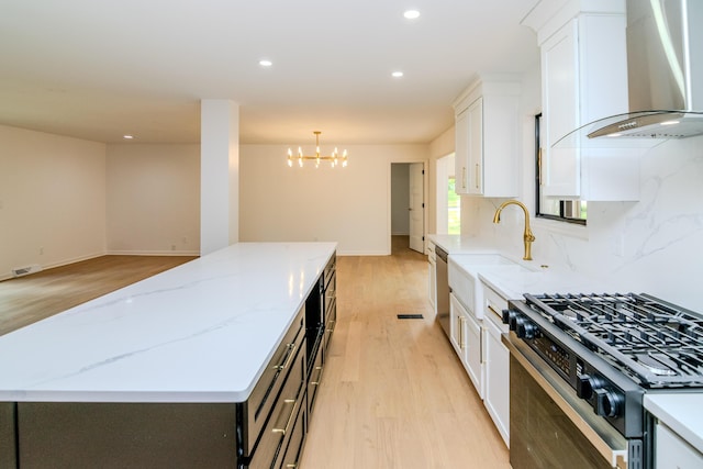 2933 Montavesta Rd, Lexington, KY 40502 - kitchen with gas stove, wall chimney exhaust hood, a center island, light wood finished floors, and white cabinetry