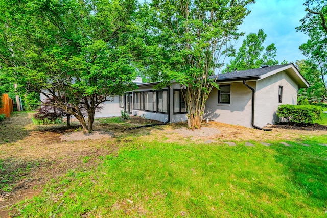 2933 Montavesta Rd, Lexington, KY 40502 - back of house with brick siding, a sunroom, and a yard
