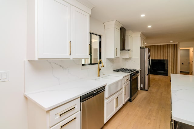 2933 Montavesta Rd, Lexington, KY 40502 - kitchen featuring stainless steel appliances, wall chimney range hood, a sink, white cabinets, and backsplash