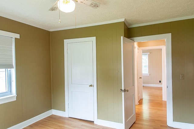 135 Rolling Acres Dr, Frankfort, KY 40601 - unfurnished bedroom with light wood finished floors, crown molding, baseboards, and a textured ceiling