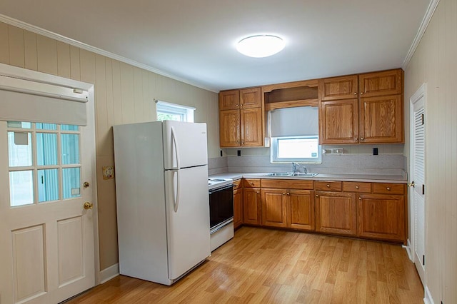 135 Rolling Acres Dr, Frankfort, KY 40601 - kitchen with white appliances, a sink, brown cabinetry, ornamental molding, and light wood-type flooring