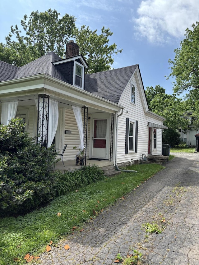 321 Clay Ave, Lexington, KY 40502 - view of front of house featuring a shingled roof, a chimney, and covered porch