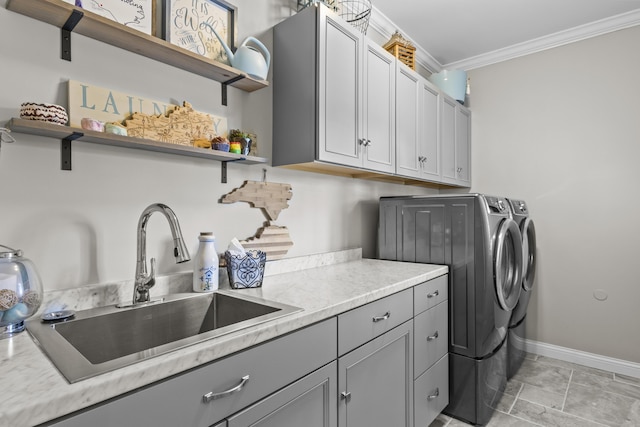 594 Earlymeade Dr, Winchester, KY 40391 - laundry area featuring washer and dryer, ornamental molding, cabinet space, baseboards, and light stone finish floors