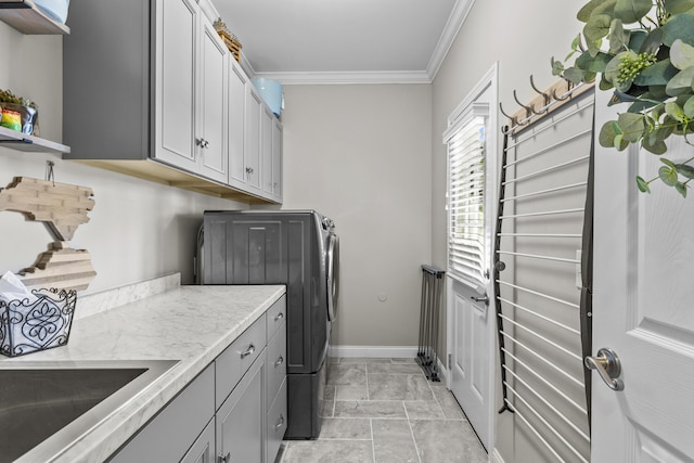 594 Earlymeade Dr, Winchester, KY 40391 - laundry area with washing machine and dryer, ornamental molding, cabinet space, baseboards, and light marble finish flooring