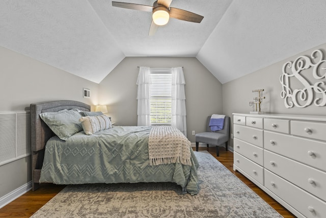 594 Earlymeade Dr, Winchester, KY 40391 - bedroom featuring dark wood-style flooring, vaulted ceiling, ceiling fan, baseboards, and a textured ceiling