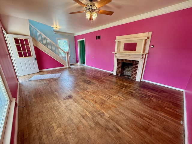 215 Bellevue Ave, Wilmore, KY 40390 - unfurnished living room with stairs, hardwood / wood-style flooring, a fireplace, a ceiling fan, and ornamental molding