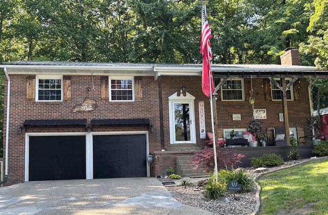 1512 Maple Ln, Corbin, KY 40701 - raised ranch with a garage, asphalt driveway, brick siding, a chimney, and metal roof