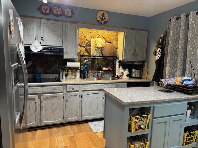 1512 Maple Ln, Corbin, KY 40701 - kitchen with stainless steel refrigerator with ice dispenser, a sink, extractor fan, black electric stovetop, and light countertops