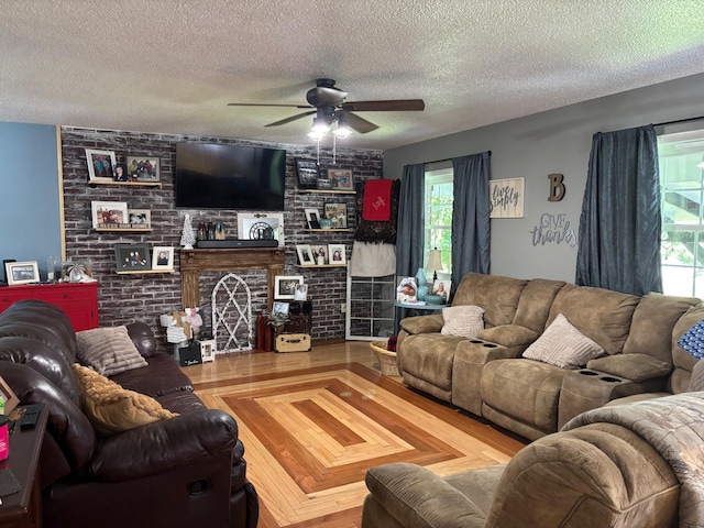 1512 Maple Ln, Corbin, KY 40701 - living area featuring a textured ceiling, ceiling fan, and a fireplace