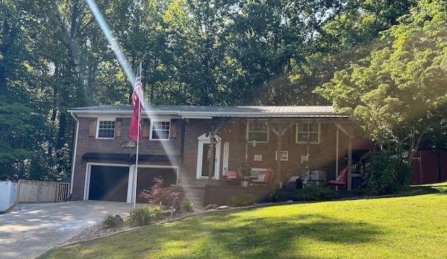 1512 Maple Ln, Corbin, KY 40701 - raised ranch with concrete driveway, an attached garage, brick siding, and metal roof