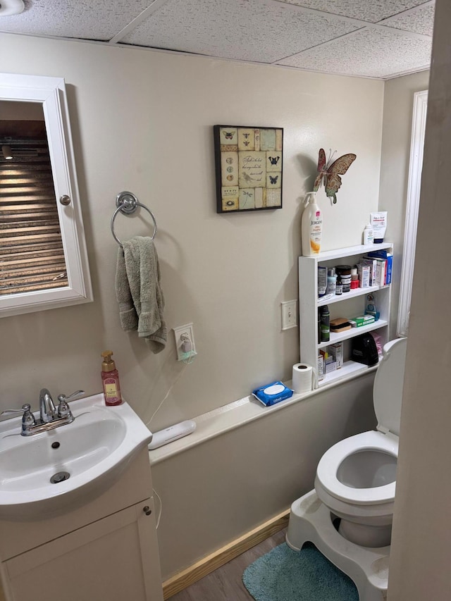1512 Maple Ln, Corbin, KY 40701 - bathroom with toilet, vanity, wood finished floors, and a paneled ceiling