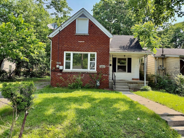 923 Whitney Ave, Lexington, KY 40508 - view of front facade featuring covered porch, a front yard, brick siding, and a shingled roof