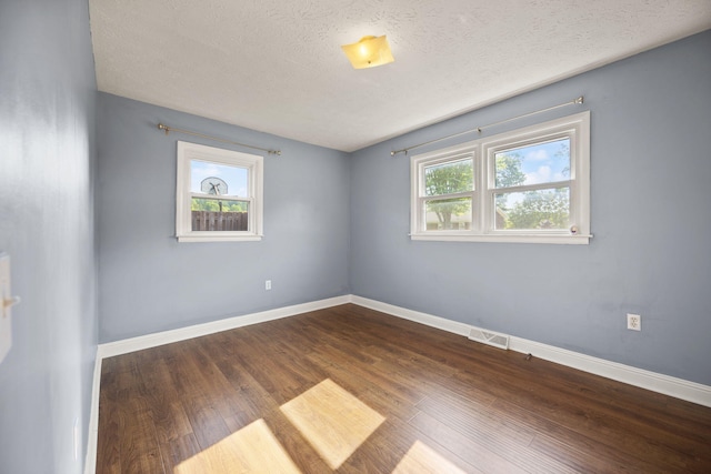 141 Springfield Dr, Corbin, KY 40701 - unfurnished room with dark wood-style flooring, a textured ceiling, and baseboards