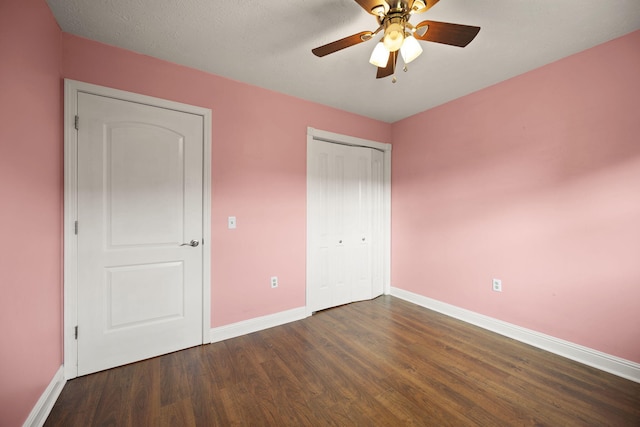 141 Springfield Dr, Corbin, KY 40701 - unfurnished bedroom with baseboards, dark wood finished floors, a closet, and ceiling fan