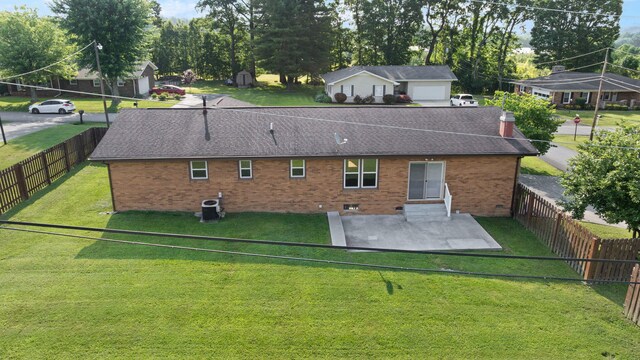 141 Springfield Dr, Corbin, KY 40701 - rear view of property featuring brick siding, a patio, a shingled roof, central AC unit, and entry steps