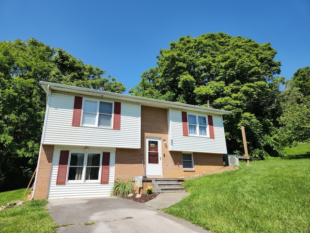 50 Ford Dr, Mount Vernon, KY 40456 - split foyer home featuring brick siding, a front yard, and central AC unit