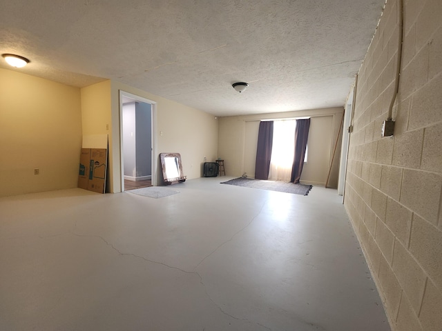 50 Ford Dr, Mount Vernon, KY 40456 - spare room featuring concrete floors, concrete block wall, and a textured ceiling