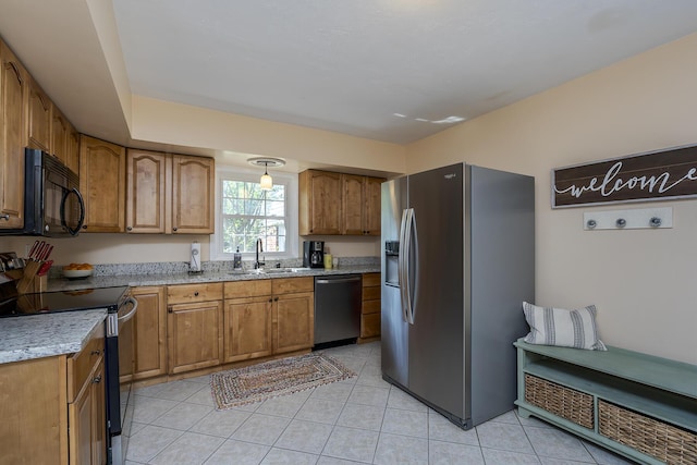 3506 Newport Dr, Lexington, KY 40517 - kitchen featuring stainless steel appliances, a sink, brown cabinetry, and light tile patterned flooring