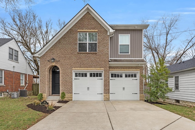 100 Goodrich Ave, Lexington, KY 40503 - view of front facade featuring board and batten siding, brick siding, driveway, an attached garage, and central air condition unit