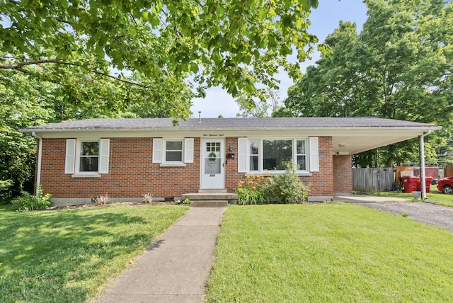 103 Cypress St, Nicholasville, KY 40356 - view of front of home with brick siding, asphalt driveway, and a carport