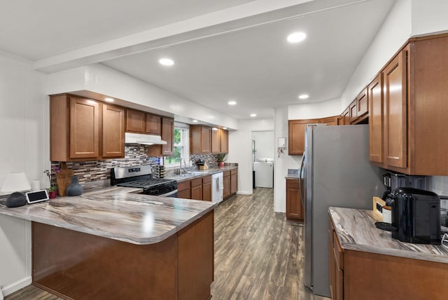 103 Cypress St, Nicholasville, KY 40356 - kitchen with stainless steel appliances, under cabinet range hood, brown cabinetry, dark wood-style flooring, and recessed lighting