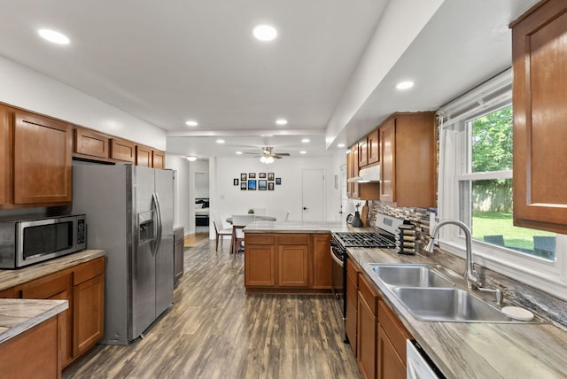 103 Cypress St, Nicholasville, KY 40356 - kitchen with appliances with stainless steel finishes, under cabinet range hood, a sink, recessed lighting, and brown cabinets