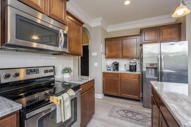 162 Johnstone Trl, Georgetown, KY 40324 - kitchen with appliances with stainless steel finishes, light stone counters, arched walkways, brown cabinets, and backsplash