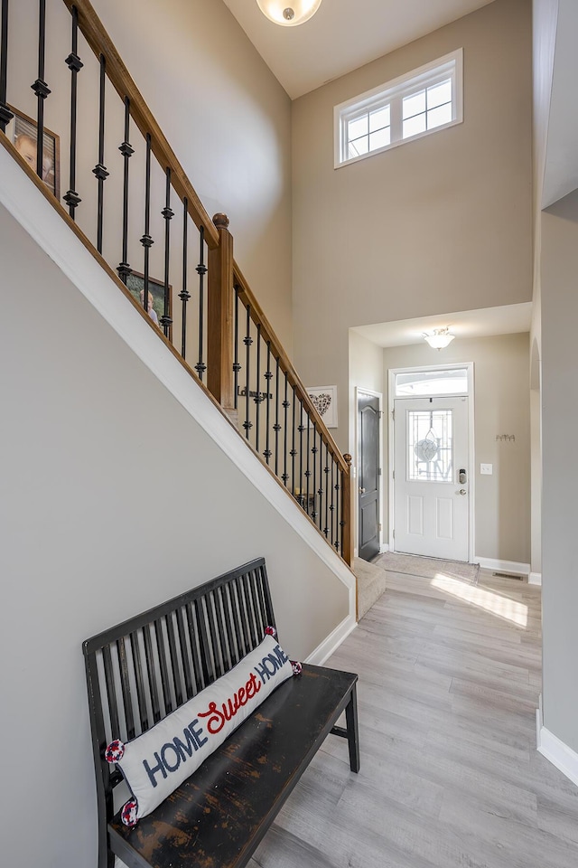 162 Johnstone Trl, Georgetown, KY 40324 - foyer entrance featuring a towering ceiling, stairway, wood finished floors, plenty of natural light, and baseboards