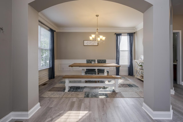 162 Johnstone Trl, Georgetown, KY 40324 - dining room with arched walkways, healthy amount of natural light, wood finished floors, ornamental molding, and wainscoting
