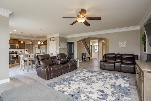 162 Johnstone Trl, Georgetown, KY 40324 - living room with arched walkways, light wood-style floors, a ceiling fan, crown molding, and stairway