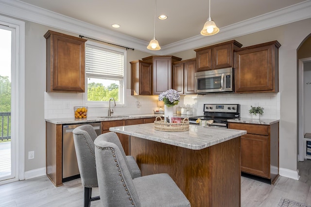 162 Johnstone Trl, Georgetown, KY 40324 - kitchen featuring stainless steel appliances, a sink, light wood-style flooring, decorative backsplash, and ornamental molding
