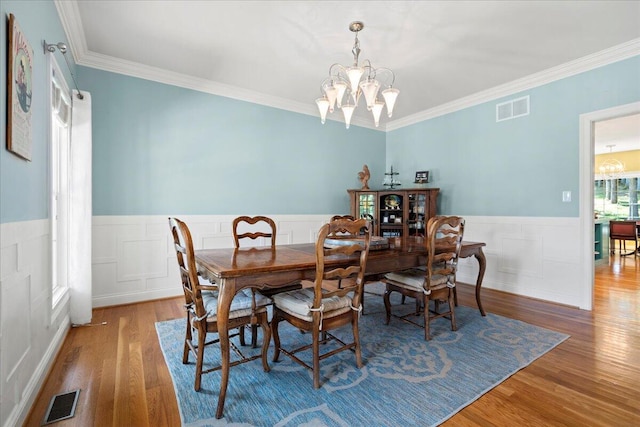 143 Winding View Trl, Georgetown, KY 40324 - dining room featuring a chandelier, wood finished floors, wainscoting, ornamental molding, and a decorative wall