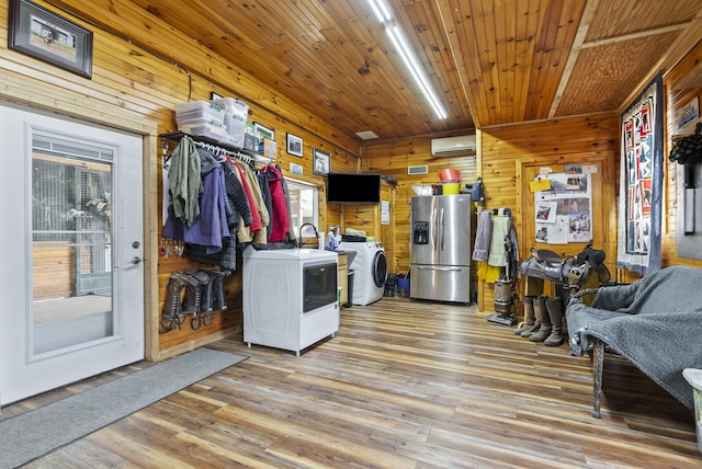 106 Sand Piper Ct, Midway, KY 40347 - kitchen featuring stainless steel refrigerator with ice dispenser, washing machine and dryer, wooden walls, a wall unit AC, and light wood-style floors