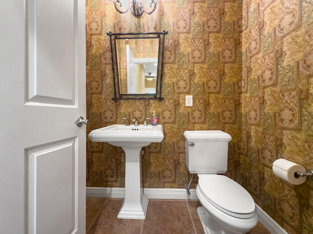 2625 Flying Ebony Dr, Lexington, KY 40509 - half bath with toilet, baseboards, tile patterned floors, wallpapered walls, and a sink