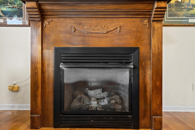 204 Keith Dr, Berea, KY 40403 - detailed view of a fireplace, baseboards, and wood finished floors