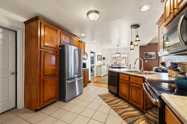 204 Keith Dr, Berea, KY 40403 - kitchen with stainless steel appliances, a sink, light tile patterned floors, pendant lighting, and brown cabinetry