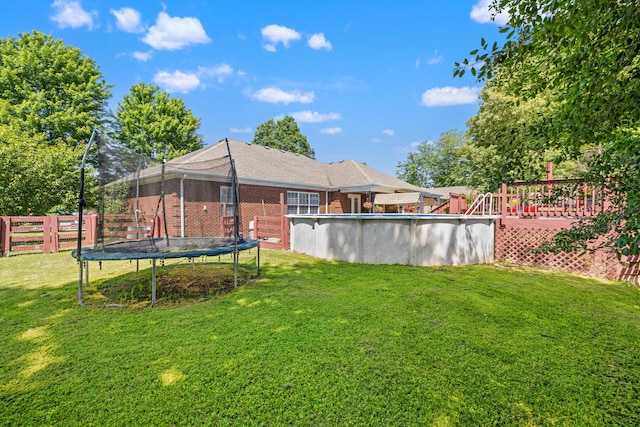 204 Keith Dr, Berea, KY 40403 - view of yard featuring a trampoline, an outdoor pool, and a wooden deck