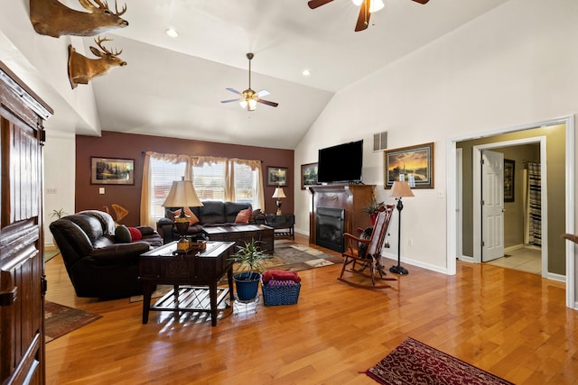 204 Keith Dr, Berea, KY 40403 - living room featuring ceiling fan, a glass covered fireplace, light wood finished floors, baseboards, and high vaulted ceiling
