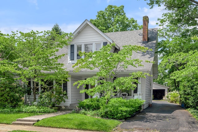 904 Aurora Ave, Lexington, KY 40502 - view of front of house with a chimney, roof with shingles, and an outbuilding