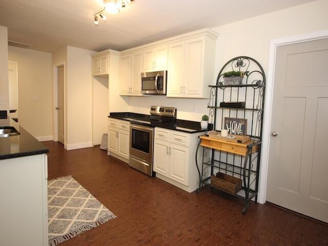91 Graysons Way, Somerset, KY 42503 - kitchen with appliances with stainless steel finishes, dark countertops, dark wood finished floors, and white cabinets