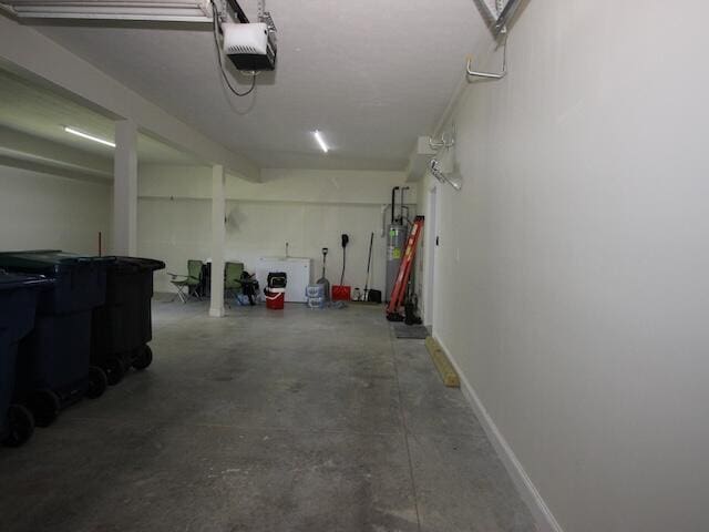 91 Graysons Way, Somerset, KY 42503 - garage featuring a garage door opener, water heater, and baseboards
