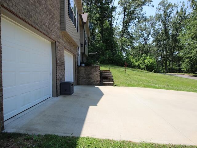 91 Graysons Way, Somerset, KY 42503 - view of patio with a garage and driveway
