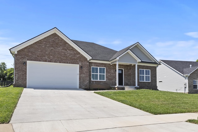 202 Max Cavnes Rd, Danville, KY 40422 - view of front of house featuring brick siding, concrete driveway, a front yard, and an attached garage