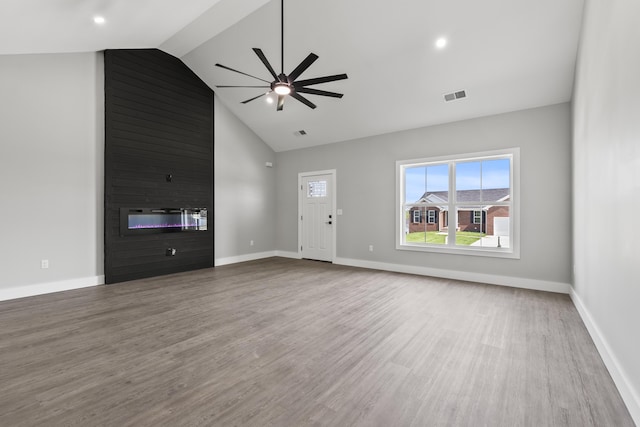 202 Max Cavnes Rd, Danville, KY 40422 - unfurnished living room featuring a large fireplace, a ceiling fan, wood finished floors, and high vaulted ceiling
