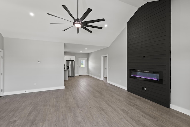 202 Max Cavnes Rd, Danville, KY 40422 - unfurnished living room featuring a large fireplace, ceiling fan, wood finished floors, recessed lighting, and high vaulted ceiling
