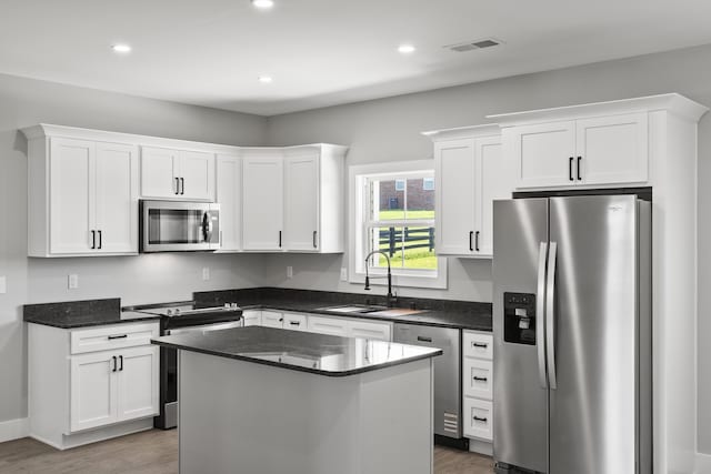 202 Max Cavnes Rd, Danville, KY 40422 - kitchen featuring appliances with stainless steel finishes, wood finished floors, white cabinetry, a center island, and recessed lighting