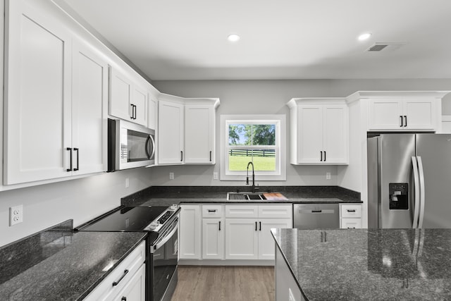 202 Max Cavnes Rd, Danville, KY 40422 - kitchen with stainless steel appliances, white cabinets, light wood-style flooring, recessed lighting, and dark stone countertops