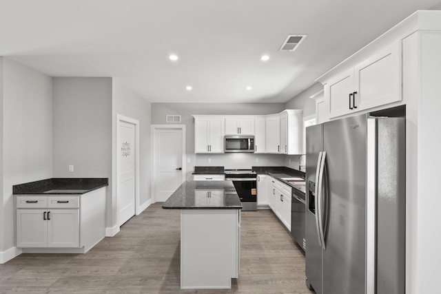 202 Max Cavnes Rd, Danville, KY 40422 - kitchen featuring appliances with stainless steel finishes, white cabinets, a kitchen island, light wood-style flooring, and recessed lighting