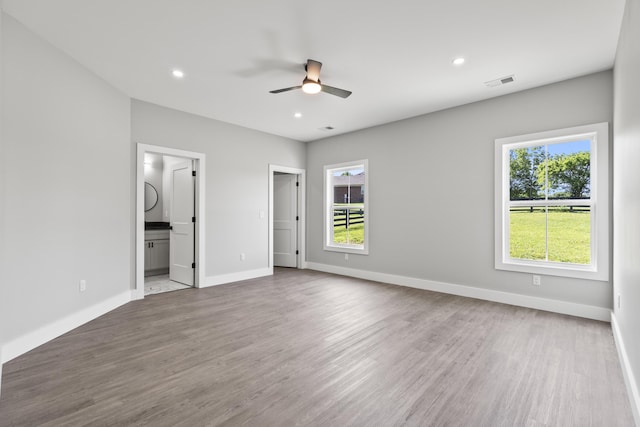 202 Max Cavnes Rd, Danville, KY 40422 - unfurnished bedroom featuring multiple windows, wood finished floors, recessed lighting, and connected bathroom